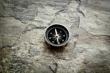 Fototapeta na wymiar Compass - small and stylish - on grey background copy space