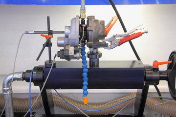 Car turbo charger repair equipment, turbo compressor on machine tool adjustment close up