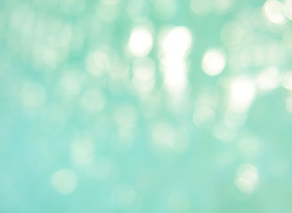 Soft focus bokeh light effects over a rippled