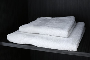 White towels on a black shelf