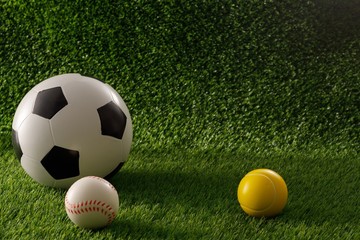 Soccer and baseball balls on a green field. The concept of football matches. Copy space.