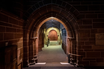 Obraz premium Scary pointy arcade, made of stone bricks leading to a dead end corridor dimly lit. Concept mystery and danger.