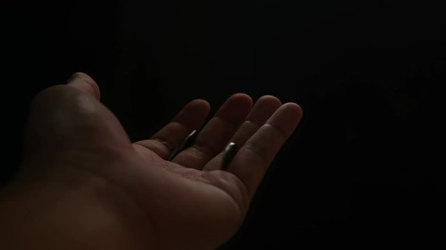 Close up Hand of philanthropist giving coin to homeless, isolated on back background. Concept of give donate charity finance and grant.