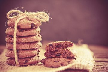 Still life of Close up stacked chocolate chip cookies on  napkin with rustic background