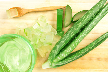 the sliced and leaf of fresh aloe vera on  wooden plate , natural clear gel as the star beauty ingredient  for skin care