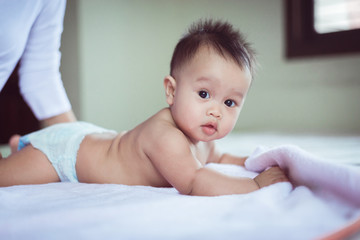 Cute baby crawling at bedroom after wake up in the morning,Mother take care and support,Childhood and baby care concept