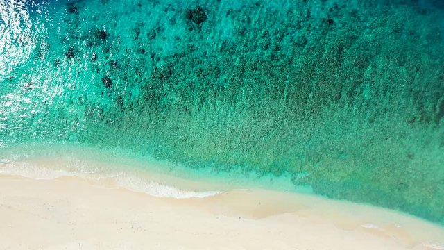 Tropical sea water texture, coral reef lagoon and turquoise blue water and white sand in South Pacific Ocean, French Polynesia, Tahiti.