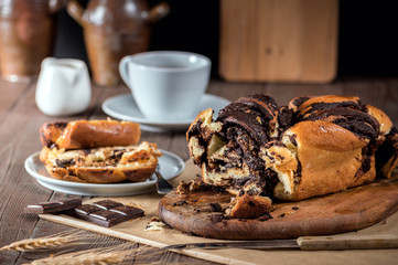 Swirl cake with chocolate on wooden background