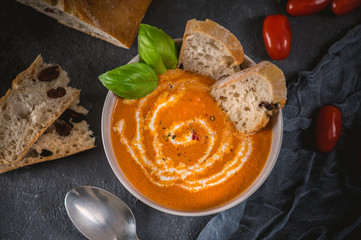 Tomato soup with fresh basil, served with cream and sourdough bread