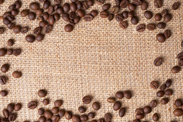 Arrangement of coffee beans on jute with space for copy