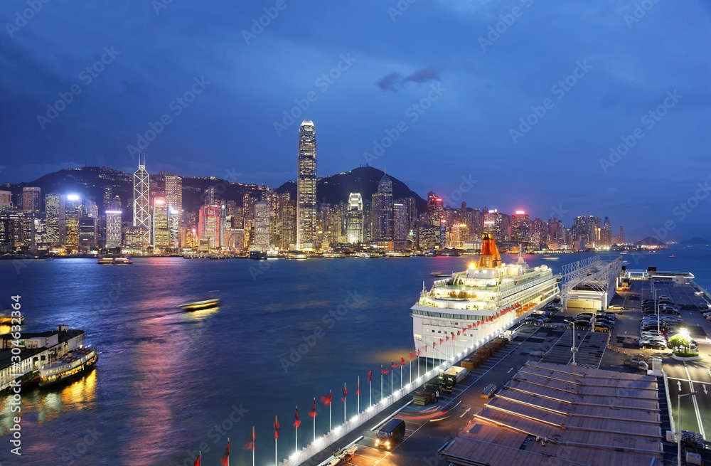 Wall mural night skyline of hong kong, with landmark ifc tower standing amid skyscrapers by victoria harbour, a