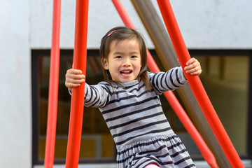 Little girl playing outdoors in the sun
