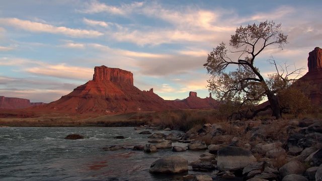 Panning view through Castle Valley over the Colorado River in Utah in the old west during sunset.