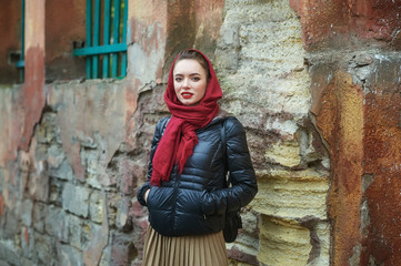 young girl on the street of the old town on an autumn day