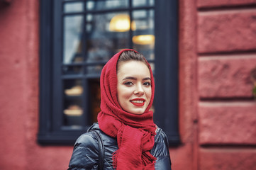 Outdoor portrait of a young woman in the autumn city