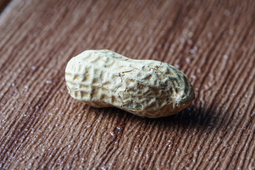 The peanut also known as ground nut. Frame over brown bckground