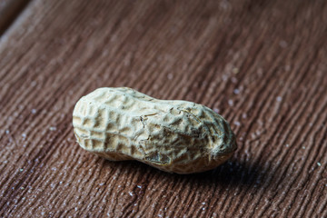 The peanut also known as ground nut. Frame over brown bckground