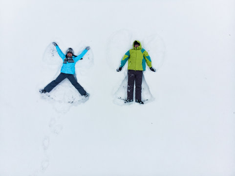 Couple Having Fun Making Snow Angel