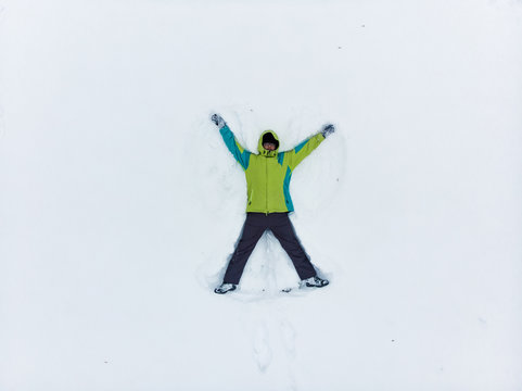 overhead view of man making snow angel