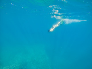 woman in flipper view underwater beach vacation