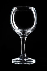 Glossy empty wine glass close up on a dark background