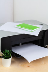 Office printer close up on a wooden table