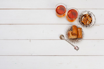 Cup of hot tea and a plate of turkish desserts