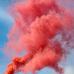 Red smoke on a blue sky