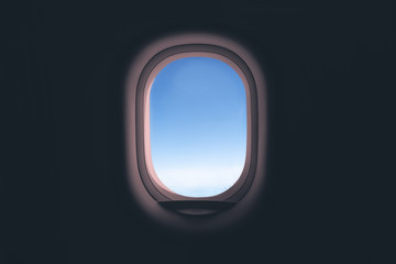Airplane window. Glass in focus sky blurry