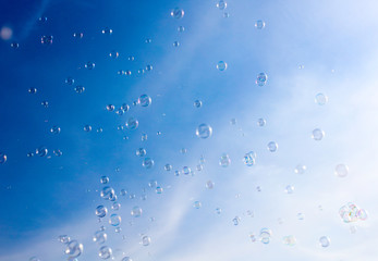 Soap bubbles fly in the blue sky