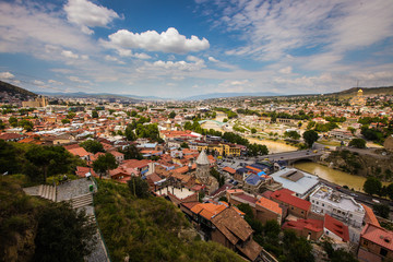 Panorama of tbilisi, a capital of Georgia on a warm summer day with some fluffy cloluds.