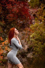 Beautiful young woman enjoys the autumn warmth