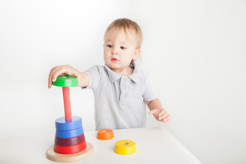Child playing with wood stacking toy