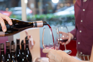 pouring red wine into glass