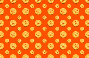 Fototapeta na wymiar Salty biscuits crackers top view pattern on red background