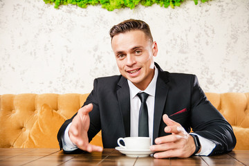 Businessman is negotiating a cup of coffee