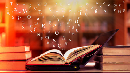 Open book on the table and English alphabet Floating above the book