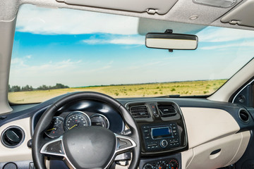 shining cockpit view of a modern car driving in desert  