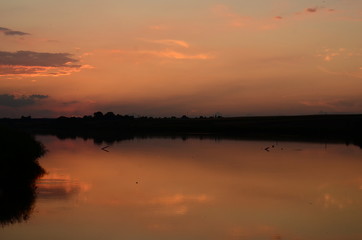 Fototapeta na wymiar Sunset grass on river sunset landscape
