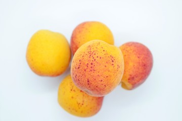 Delicious beautiful apricots located on a white background