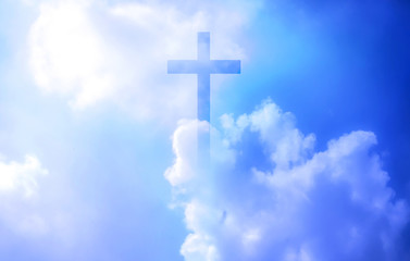 Christian cross appeared bright in the sky with soft fluffy clouds, white, beautiful colors. With the light shining as hope, love and freedom in the sky background