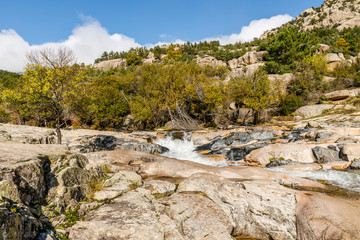 Fototapeta na wymiar River in La Pedriza, in the mountains of Madrid, area characterized by large granite rocks