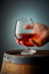 glass of cognac in human hand