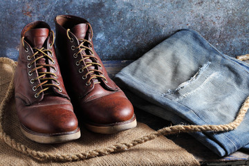 Safety shoes and old blue jeans on rustic background, Safety shoes and old blue jeans in a store
