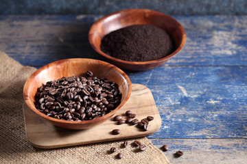 Coffee beans in wooden cup on rustic wooden table with a blank space for a text, Coffee in cup on loft background