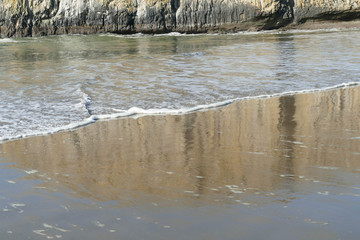 Elephant rock with reflections in incoming tide