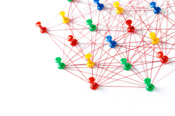 Network with colorful pins and string,  linked together with string on a white background suggesting a network of connections.