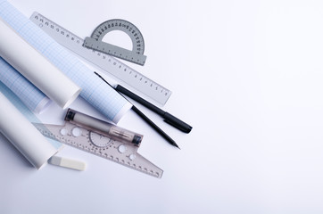Top view of constructor professional tools on the white blank paper.Protractor, pencils, t-square,...