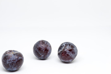 freshly caught tree plum on white background