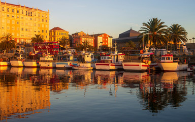 Boats Reflected in Golden Light at Fishing Port of Ferrol La Coruna Galicia